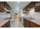 Bright kitchen with white countertops and view to backyard, complemented by rich wood cabinetry at 3631 W 79Th Ave # A2, Westminster, CO 80030