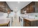 Functional kitchen with wood cabinets, white appliances, and tiled floor, ready for culinary adventures at 3631 W 79Th Ave # A2, Westminster, CO 80030