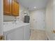 Functional laundry room features washer, dryer, and overhead cabinets for efficient space saving at 3631 W 79Th Ave # A2, Westminster, CO 80030