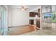 Open living space with mirrored wall near kitchen, featuring a ceiling fan and backyard view at 3631 W 79Th Ave # A2, Westminster, CO 80030