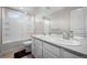 Bathroom with dual sinks, white cabinetry and a shower/bathtub combo at 918 Honey Berry Ct, Elizabeth, CO 80107