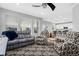 Spacious living room with windows, ceiling fan, and open to the kitchen/dining area at 918 Honey Berry Ct, Elizabeth, CO 80107