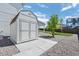 Backyard storage shed on concrete foundation and rock border; perfectly sized to store your yard maintenance equipment and tools at 918 Honey Berry Ct, Elizabeth, CO 80107