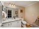 Well lit bathroom with granite countertop, white cabinets, and a view to the adjacent wine cellar at 4192 Timbervale Dr, Evergreen, CO 80439