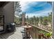 Inviting deck with outdoor seating, grill, and umbrella for entertaining and enjoying the scenery at 4192 Timbervale Dr, Evergreen, CO 80439