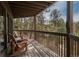 Inviting outdoor deck with seating overlooking the scenic trees and nature at 4192 Timbervale Dr, Evergreen, CO 80439