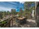 Relaxing deck with outdoor seating and lush views of the surrounding trees and nature at 4192 Timbervale Dr, Evergreen, CO 80439