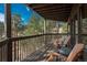 Charming outdoor deck with views of surrounding pine trees at 4192 Timbervale Dr, Evergreen, CO 80439