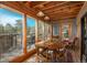 Sunlit dining room with wood-paneled ceiling, large windows, and deck access, offering scenic views at 4192 Timbervale Dr, Evergreen, CO 80439
