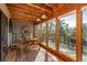 Inviting dining room with wood accents and large windows, perfect for enjoying meals with a view of the outdoors at 4192 Timbervale Dr, Evergreen, CO 80439
