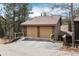 Spacious two-car garage with ample driveway parking, providing convenient and secure vehicle storage at 4192 Timbervale Dr, Evergreen, CO 80439