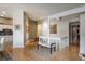 Open hallway leading to a kitchen with a bench and hardwood floors at 4192 Timbervale Dr, Evergreen, CO 80439
