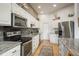 Modern kitchen features stainless steel appliances, granite counters and white cabinets at 4192 Timbervale Dr, Evergreen, CO 80439
