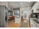 Open-concept kitchen with granite island, stainless appliances, and dining area at 4192 Timbervale Dr, Evergreen, CO 80439