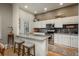 Bright kitchen featuring granite countertops, stainless steel appliances, and white cabinetry at 4192 Timbervale Dr, Evergreen, CO 80439