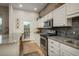 Charming kitchen boasting stone backsplash, stainless appliances, and a door to the deck at 4192 Timbervale Dr, Evergreen, CO 80439