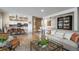 Bright living space with open floor plan, wood floors, and an adjacent dining area at 4192 Timbervale Dr, Evergreen, CO 80439
