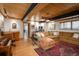 Open living room with wood ceiling, large sectional couch and wet bar area perfect for entertaining guests at 4192 Timbervale Dr, Evergreen, CO 80439