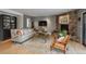 Cozy living room with a stone fireplace, hardwood floors, and stylish furnishings creating a warm and inviting space at 4192 Timbervale Dr, Evergreen, CO 80439