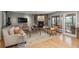 Comfortable living room features a stone fireplace, hardwood floors and access to the outdoor deck at 4192 Timbervale Dr, Evergreen, CO 80439