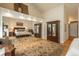 Spacious main bedroom with a large mirrored wardrobe, wood floors, and decorative rug at 4192 Timbervale Dr, Evergreen, CO 80439
