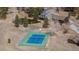 Aerial view of the community tennis courts with mountain views and ponds in the background at 4192 Timbervale Dr, Evergreen, CO 80439