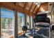 Bright workout room with a treadmill, rowing machine, and large windows offering views of the surrounding trees at 4192 Timbervale Dr, Evergreen, CO 80439