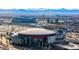 An aerial view shows the city with sports stadiums, arenas, and mountains in the background at 1435 Wazee St # 403, Denver, CO 80202
