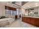 Open bathroom with soaking tub, walk-in shower, and double vanity sinks at 1435 Wazee St # 403, Denver, CO 80202