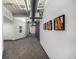 Well-lit hallway featuring unique wall art and carpet flooring, providing a modern and stylish ambiance at 1435 Wazee St # 403, Denver, CO 80202