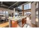 Open-concept kitchen with island, stainless steel appliances, and ample natural light at 1435 Wazee St # 403, Denver, CO 80202