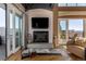 Cozy living room featuring a fireplace, TV, comfortable seating, and scenic views through sliding glass doors at 1435 Wazee St # 403, Denver, CO 80202
