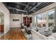 Bright living room featuring hardwood floors, a modern chandelier, and access to a private outdoor terrace at 1435 Wazee St # 403, Denver, CO 80202
