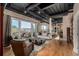 Spacious living room with hardwood floors, exposed ductwork, and a terrace overlooking the city at 1435 Wazee St # 403, Denver, CO 80202