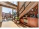 Bright living room with balcony access, stairs, and a custom bar area perfect for entertaining at 1435 Wazee St # 403, Denver, CO 80202