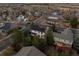 Aerial view of the home shows new solar panels, a large manicured lawn and mature trees at 1808 Southard St, Erie, CO 80516