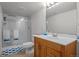 Bathroom featuring a shower with glass doors and a wood vanity with a large mirror at 1808 Southard St, Erie, CO 80516