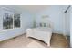 Inviting bedroom with a white bed frame, soft blue walls, and a window offering a bright view at 1808 Southard St, Erie, CO 80516