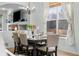 Dining area with a chandelier, seating for six, and bright window views at 1808 Southard St, Erie, CO 80516