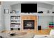 Inviting living room featuring a brick fireplace with a mantel and built-in shelving at 1808 Southard St, Erie, CO 80516