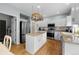 Bright kitchen featuring a center island, stainless steel appliances, and hardwood floors at 1808 Southard St, Erie, CO 80516