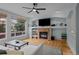 Bright living room featuring a fireplace, built-ins, recessed lighting, and large windows at 1808 Southard St, Erie, CO 80516