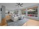 Sunlit living room with a view of the backyard, hardwood floors, and an open kitchen at 1808 Southard St, Erie, CO 80516