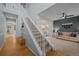 Inviting foyer with a carpeted staircase, hardwood floors, and a view into the living room at 1808 Southard St, Erie, CO 80516