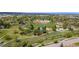 Picturesque aerial view of a park featuring pathways, trees, playground, and lush green landscape at 1518 Sepia Ave, Longmont, CO 80501