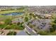 Scenic aerial view capturing tennis courts, a pond, a parking lot, and greenery at 1518 Sepia Ave, Longmont, CO 80501
