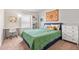Bright bedroom features a blue bedframe, green comforter, desk, and shelving, creating a stylish and functional living space at 1518 Sepia Ave, Longmont, CO 80501