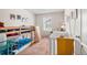 Charming bedroom featuring a bunk bed, crib, and neutral walls, creating a comfortable and inviting space for children at 1518 Sepia Ave, Longmont, CO 80501