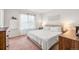 Bright bedroom with a large window, plush carpeting, and cozy decor at 1518 Sepia Ave, Longmont, CO 80501