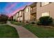 Attractive row of townhomes featuring private balconies, manicured lawns, and a welcoming walkway at 1518 Sepia Ave, Longmont, CO 80501